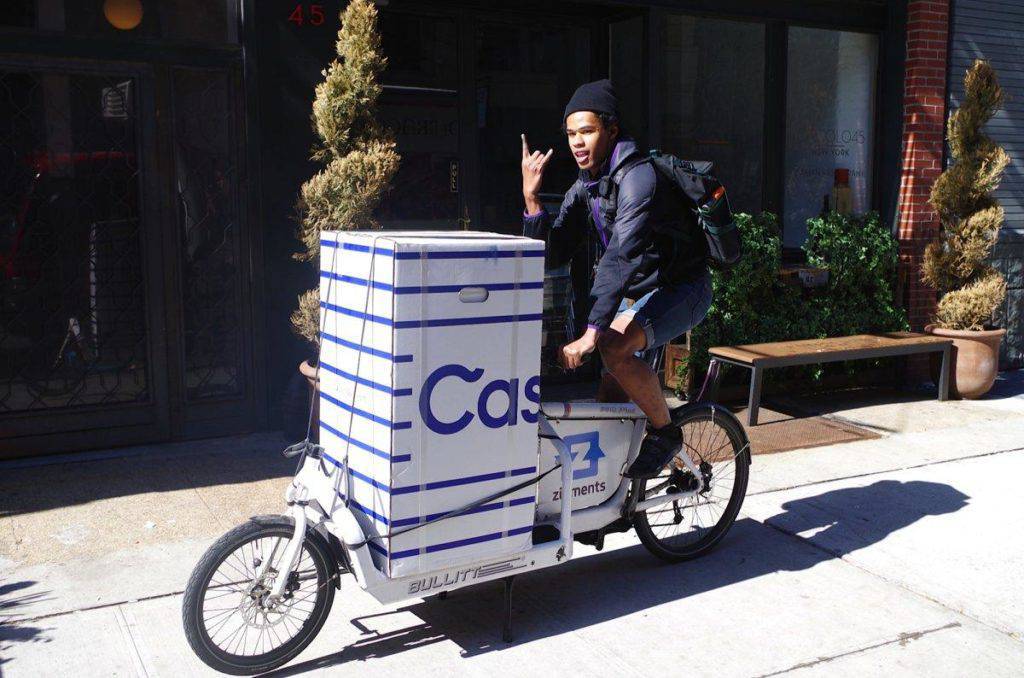 Person delivering Casper mattress on a bike